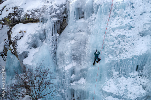 Ice climbing the North Greece, man climbing frozen waterfall. © ververidis
