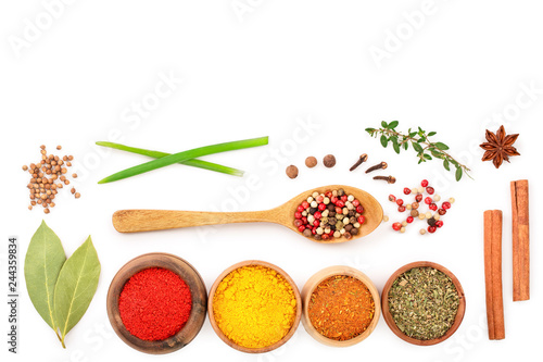 mix of spices in wooden bowl isolated on a white background with copy space for your text. Top view. Flat lay. Set or collection