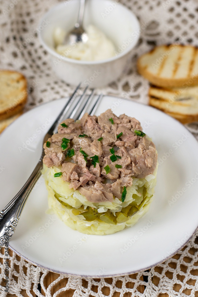 Layered salad with grated potatoes, cheese, pickles and canned cod liver Layered salad with grated potatoes, cheese, pickles and canned cod liver