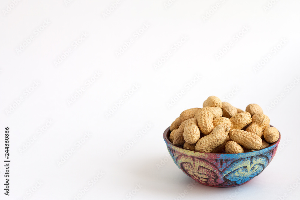 raw peanuts in shell on beautiful cup on white background, copy space raw peanuts in shell on beautiful cup on white background, copy space