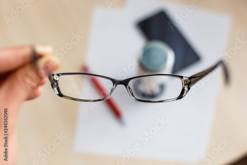 Glasses with glasses on a white background and a stamp on the print with a fountain pen, paper background