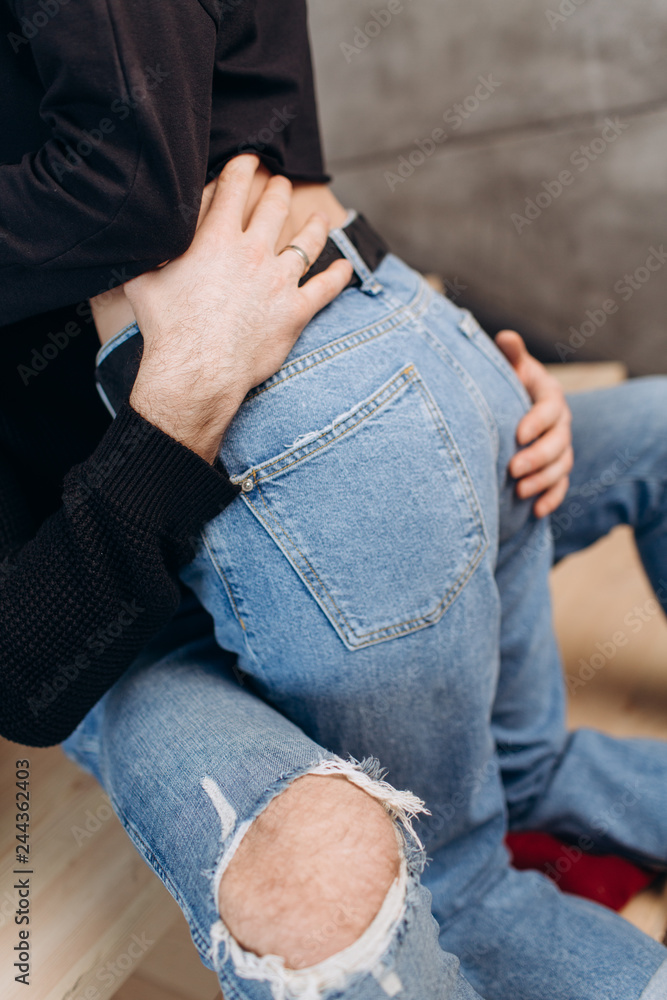 Two hipster models: a man and a woman in a blank black t-shirt, jeans and posing. in a black hat, cap, love, kisses Two hipster models: a man and a woman in a blank black t-shirt, jeans and posing. in a black hat, cap, love, kisses