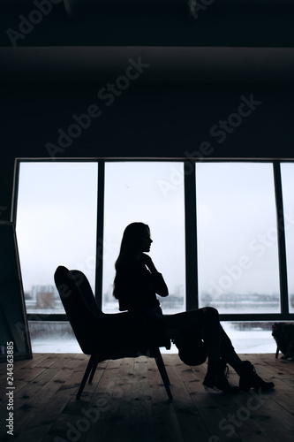 Silhouette of woman's head with waving hair, back light.