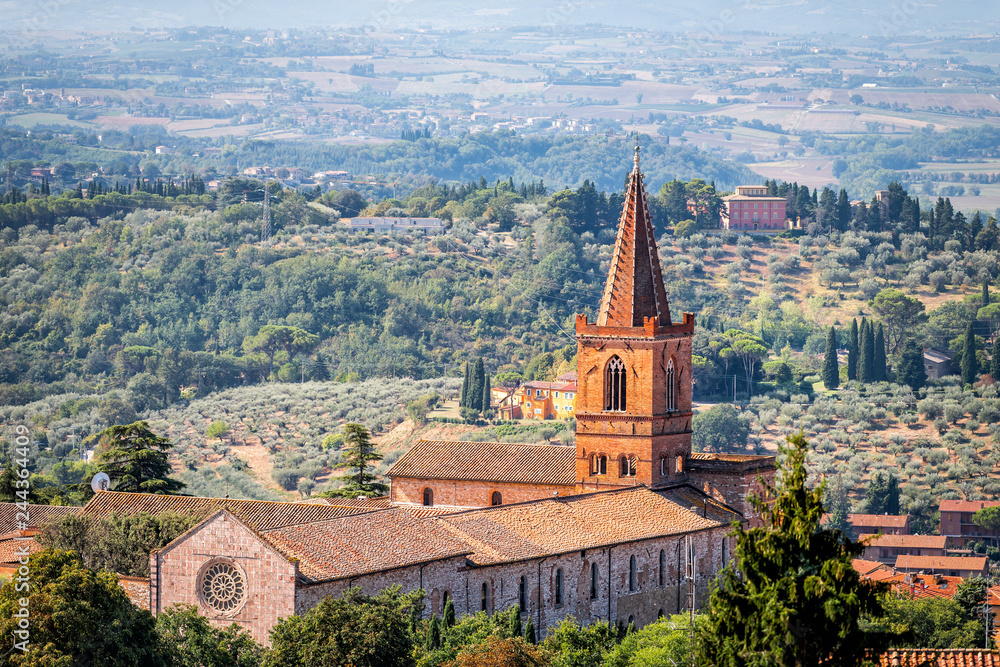 Perugia in Umbria, Italy cityscape high angle aerial view with Monastery of Santa Giuliana church tower and rooftops of town village with orange colors in summer landscape