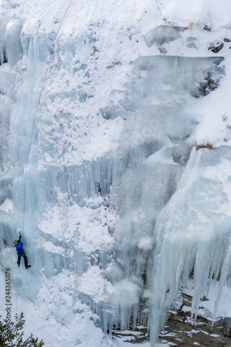 Ice climbing the North Greece  man climbing frozen waterfall.