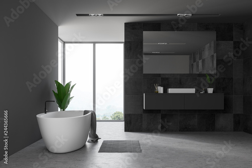 Black tile bathroom, window and tub