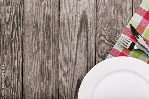 Tablecloth and cutlery on the right side on a wooden table and copy space. Food background
