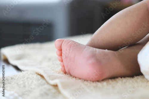 Soft focus of newborn tiny baby feet with copy space background.