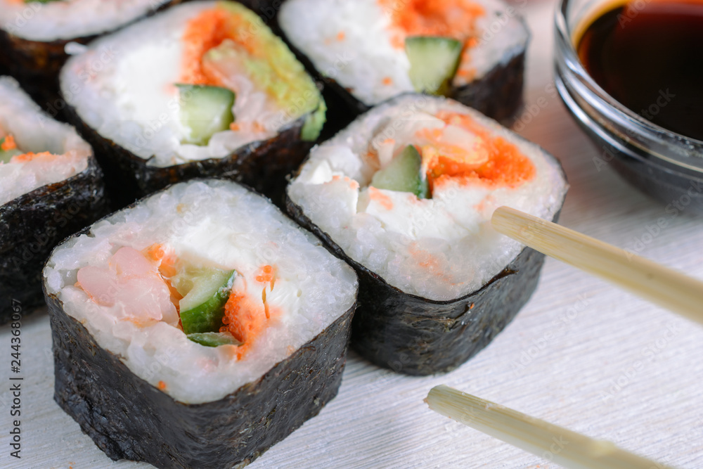 Sushi rolls made from rice, shrimp, flying fish roe and nori, cooked in a fast delivery cafe Sushi rolls made from rice, shrimp, flying fish roe and nori, cooked in a fast delivery cafe