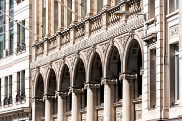 London, UK city with exterior facade view of arch colonnade columns architecture and nobody in historic downtown area showing abstract pattern detail closeup
