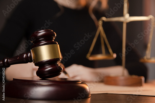 Male lawyer working with contract papers and wooden gavel on tabel in courtroom. justice and law ,attorney, court judge, concept