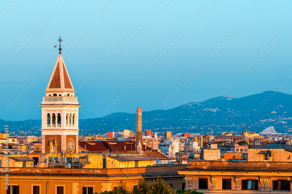 Historic Italian town of Rome, Italy cityscape skyline with high angle view of vibrant architecture old buildings tower during sunset evening night