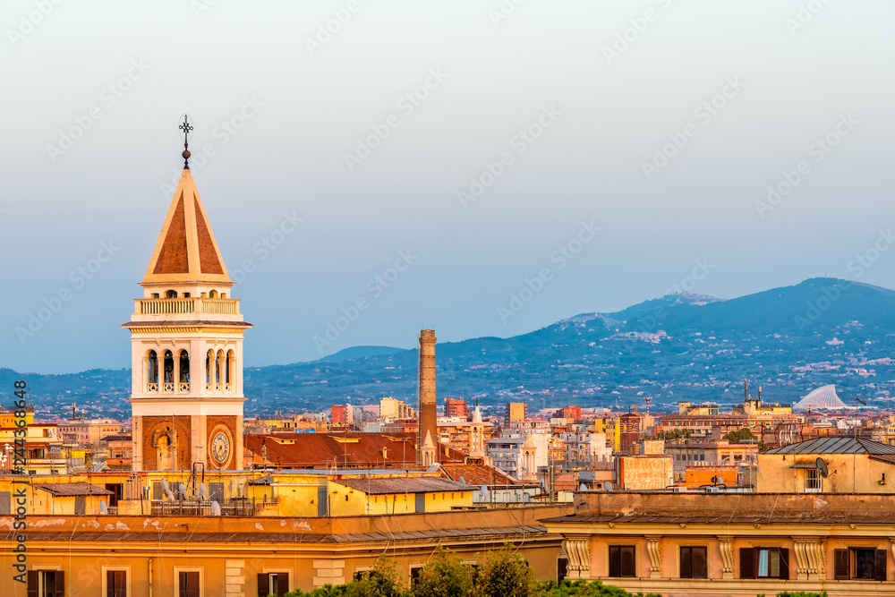 Historic Italian town of Rome, Italy cityscape skyline with high angle view of vibrant orange architecture old buildings tower during sunset evening night