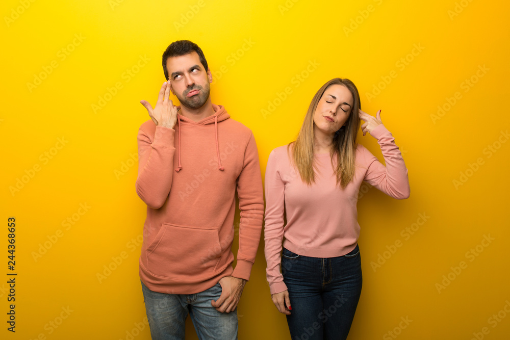 Group of two people on yellow background with problems making suicide gesture