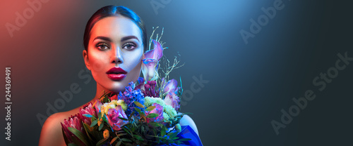 Fashion model woman in neon light, beautiful sexy girl lips with colorful bright fluorescent makeup