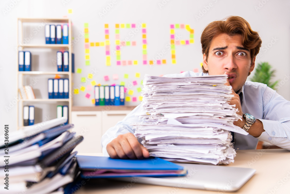 Fototapeta premium Young employee suffering from excessive work 