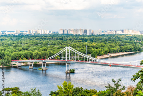 Kyiv, Ukraine overlook of city and river bridge in Kiev summer with view of residential neighborhood Darnytsia suburbs Soviet and modern buildings