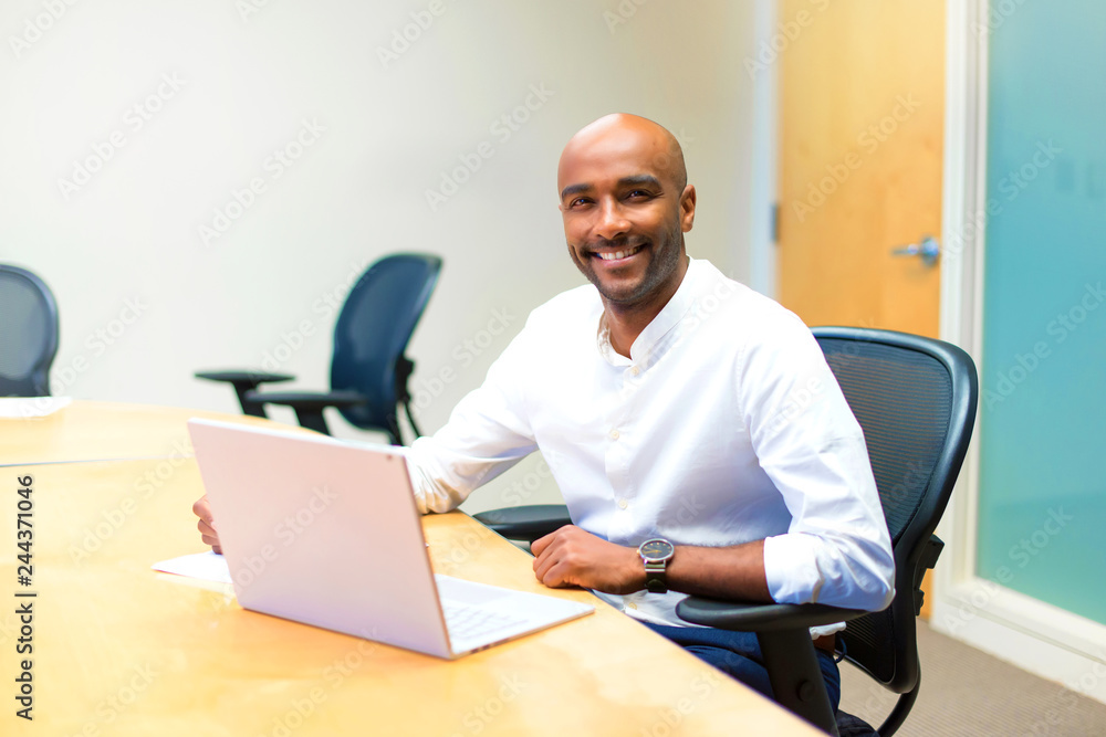 Young afro american businessman in the office with his laptop Young afro american businessman in the office with his laptop