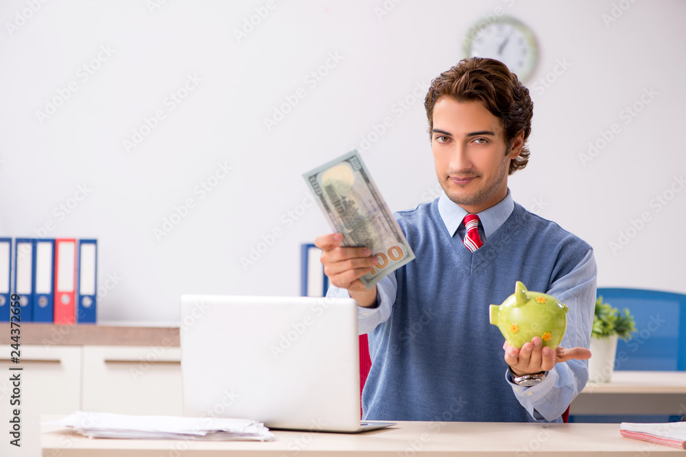 Young handsome employee working in the office Young handsome employee working in the office