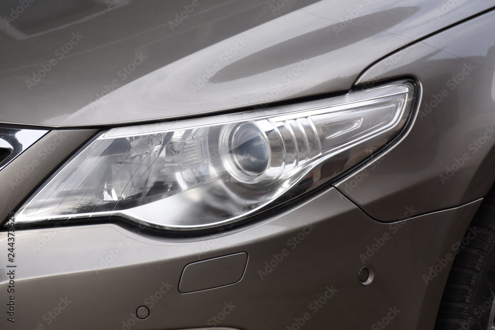 Car's exterior detail,new headlight on a  gray  car
