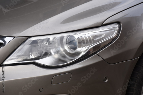 Car's exterior detail,new headlight on a gray car