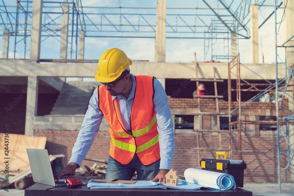 Fototapeta premium Engineer working on construction site with drawing document