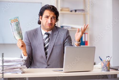 Young handsome businessman employee sitting in the office