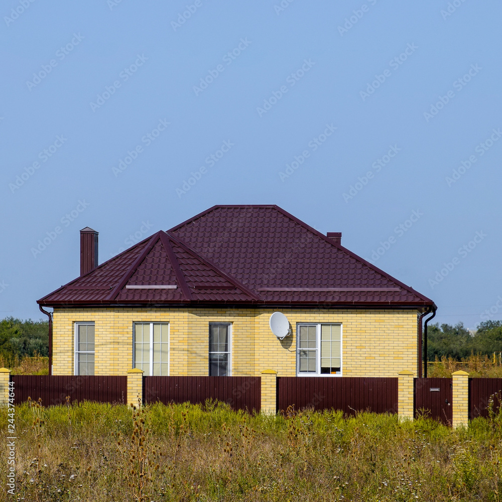 The house with plastic windows and a roof of corrugated sheet The house with plastic windows and a roof of corrugated sheet