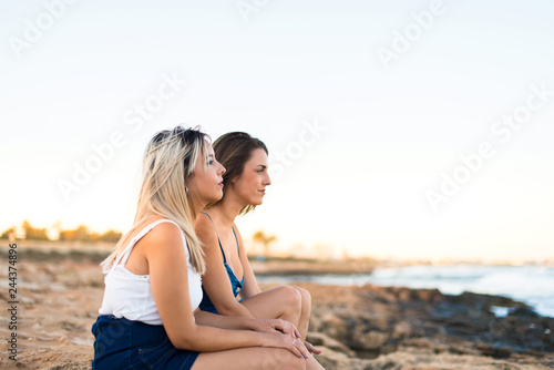 Two friends at outdoors looking the sea