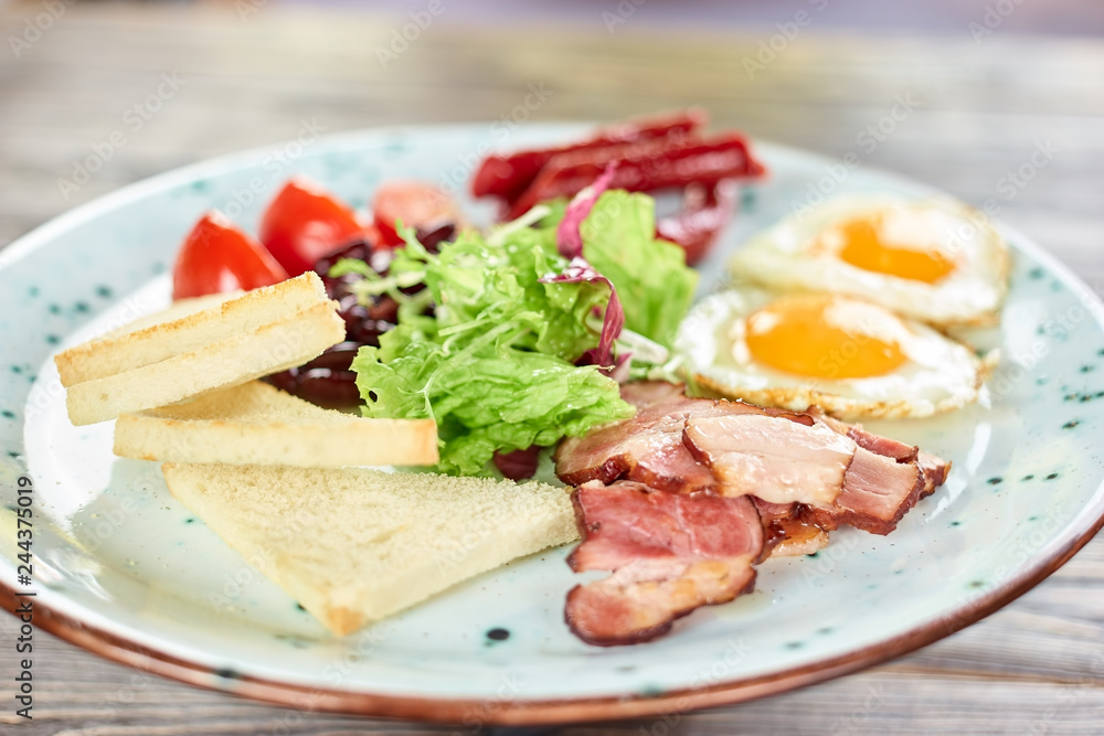 Sliced white bread, ham and lettuce salad closeup. White plate with food.