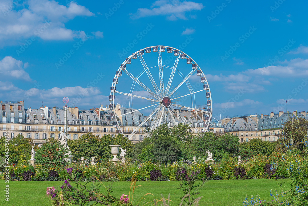 Paris Ferris wheel near the Louvre museum on sunny day Paris Ferris wheel near the Louvre museum on sunny day