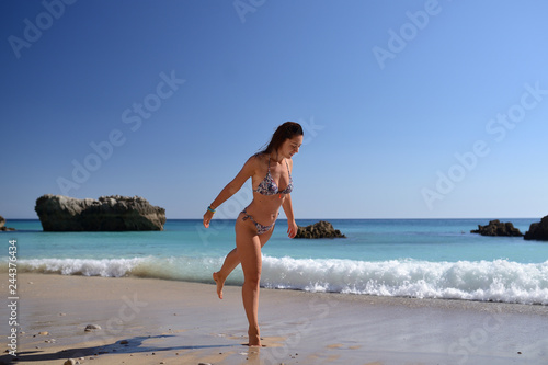girl in a bathing suit on the beach, Portugal, Atlantic Ocean