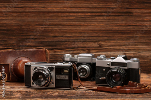 Vintage camera on wooden table and empty space for text