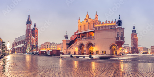 Krakow, Poland, main market square, winter night, St Mary's church and Cloth Hall illuminated