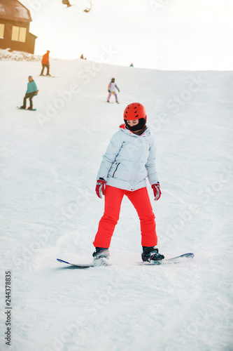 Girl try to improve her snowboarding. Sheregesh resort, Siberia, Russia