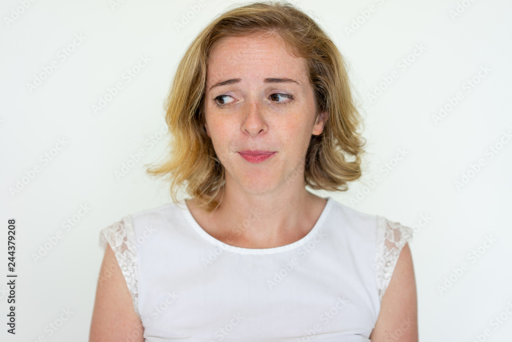 Worried young woman thinking. Pretty lady looking away. Contemplation concept. Isolated front view on white background. Worried young woman thinking. Pretty lady looking away. Contemplation concept. Isolated front view on white background.