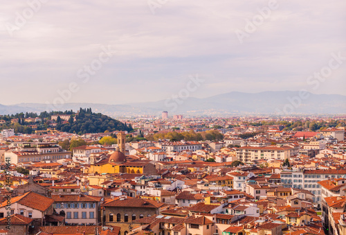 Beautifu view of city skyline, towers, basilicas, red-tiled roofs of houses and mountains, Florence, Italy