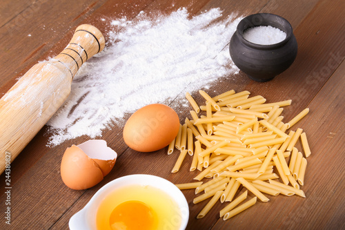 egg, flour, salt ingredients for pasta penne bolognese. Cooking concept. Top view. photo