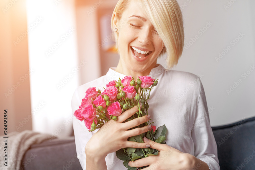 Pleased female with bunch of flowers Pleased female with bunch of flowers