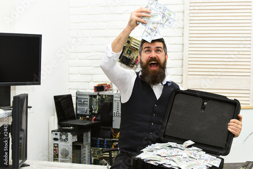 Finally rich. Withdrawing cash from electronic money. Bearded man with cash money. Business man with money case in office. Bearded hipster with dollar banknotes. Business and making money photo