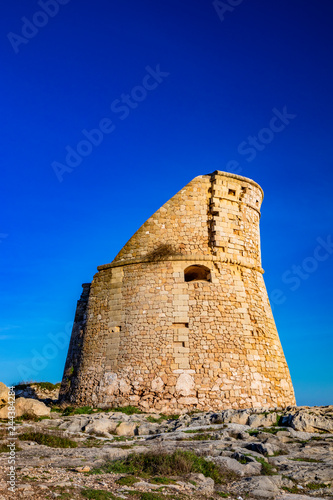 The ancient watch tower of Porto Miggiano, built on the cliffs overlooking the sea. Bleak and rocky landscape with a splendid view of the sea. Santa Cesarea Terme, Puglia, Salento, Italy.