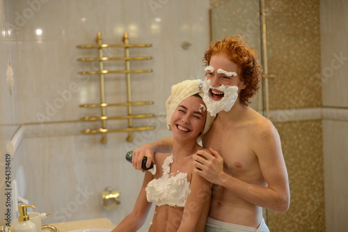 loving couple in the bathroom shaving foam