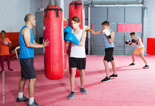 Teenagersboys posing in fighting stance at boxing gym