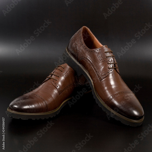 Male fashion with brown shoes on black background