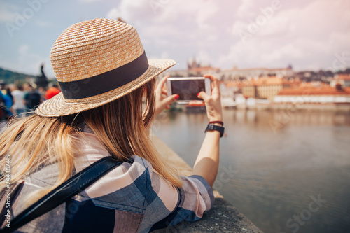 Photography Young woman happy with backpack tourist taking selfie photo camera on Charles Bridge in Prague, Czech Republic