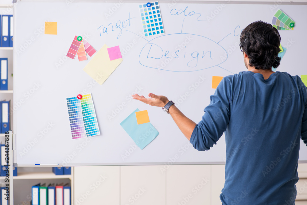 Young handsome designer working at the project Young handsome designer working at the project