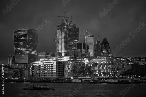 Black and white London cityline during sunset  beautiful example of contemporary modern archiecture  glass and steel on bank of Thames river in capitol of United kingdom.