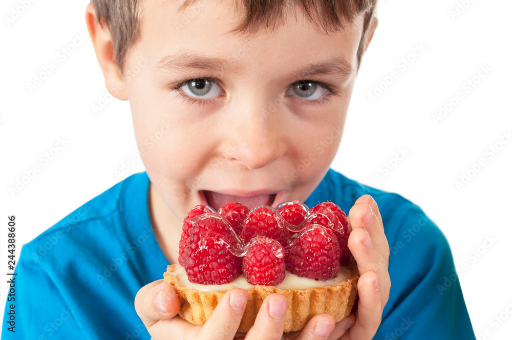 Little boy eating cakes with fruits Little boy eating cakes with fruits