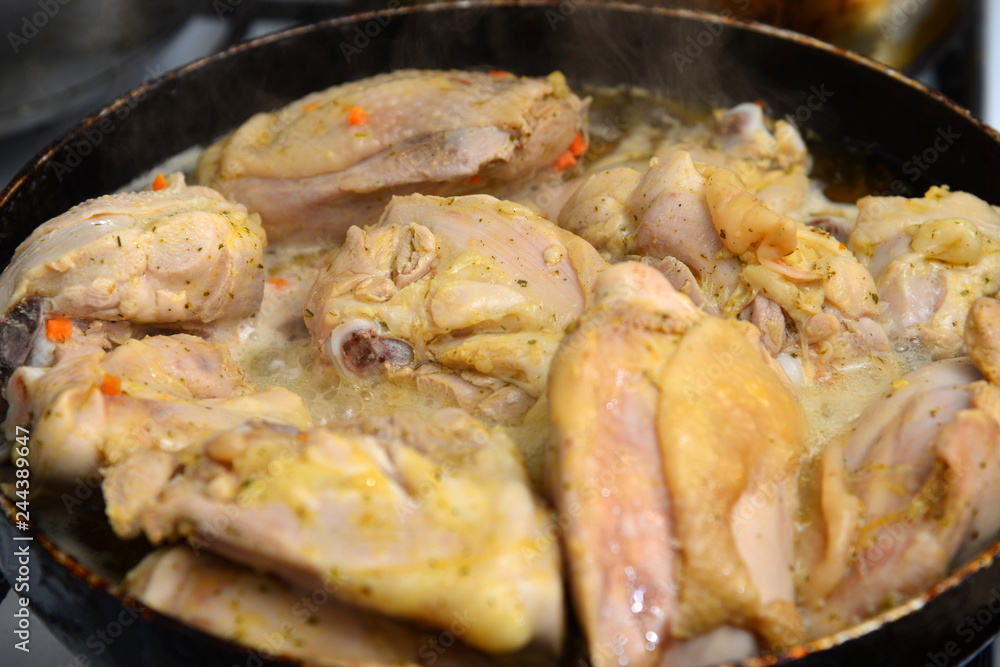 Fried chicken in a pan in oil with spices. Fried chicken in a pan in oil with spices.
