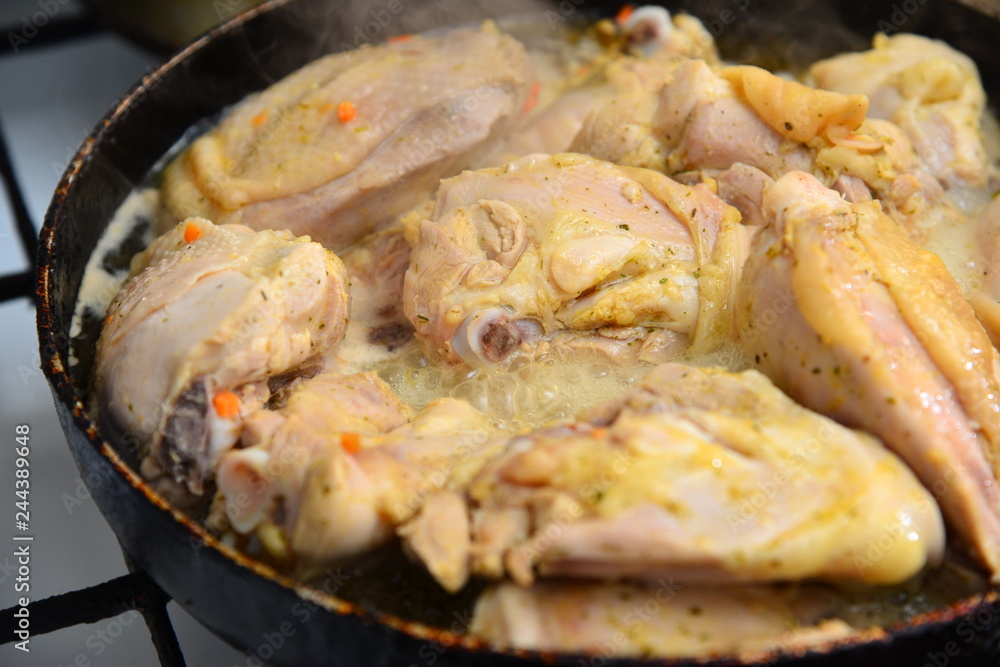 Fried chicken in a pan in oil with spices. Fried chicken in a pan in oil with spices.